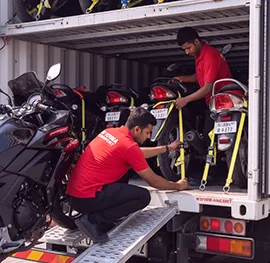 Motorcycle being carefully loaded onto the transport truck