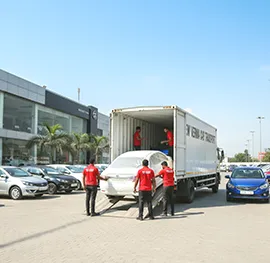 Cars delivered safely to a dealership, unloaded with care from a transport truck